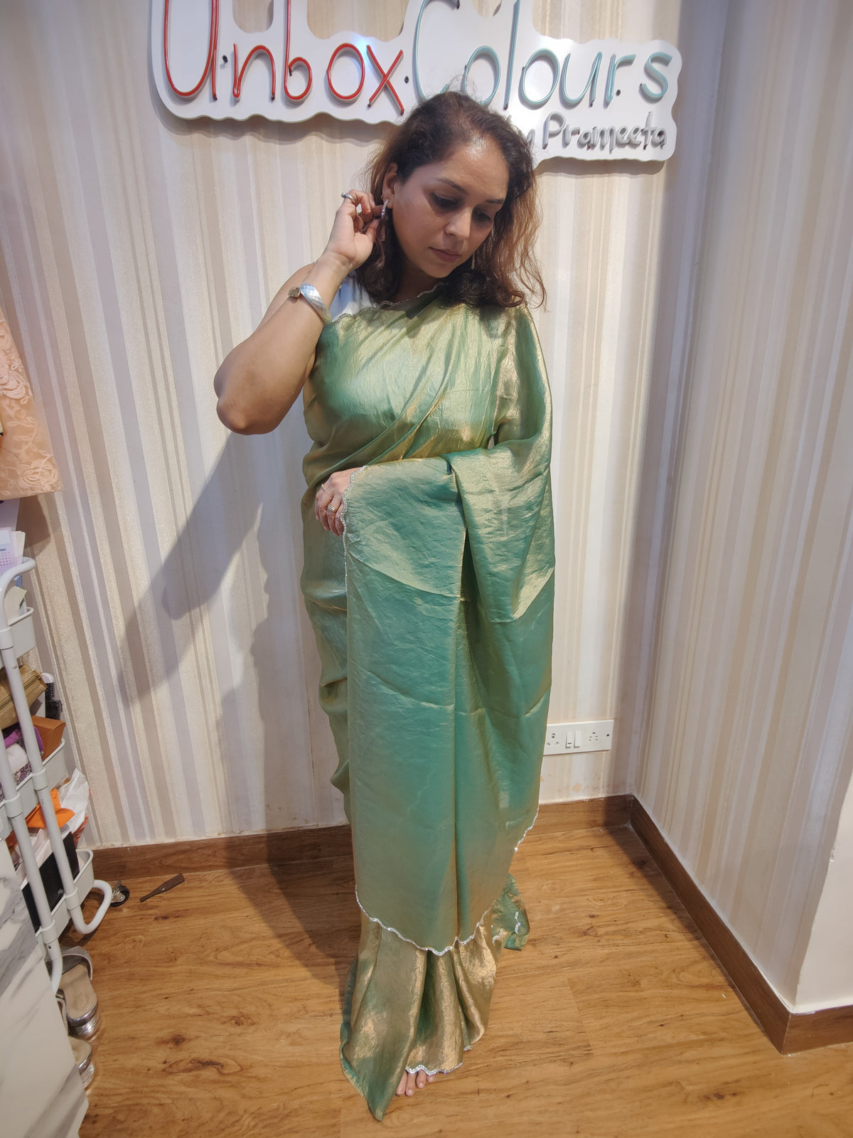 Embrace effortless elegance with Sage Green Shimmer, a graceful Soft Space Silk ready-to-wear saree from Aura Drapes by Unbox Colours, designed for style, comfort & modern sophistication. Featuring a soothing sage green shimmer with a soft, luxurious drape, this pre-stitched saree is perfect for festive celebrations, wedding functions, cocktail parties, receptions, day events & elegant family gatherings. Lightweight, stylish & easy to wear—drape it in minutes & shine with understated glamour.