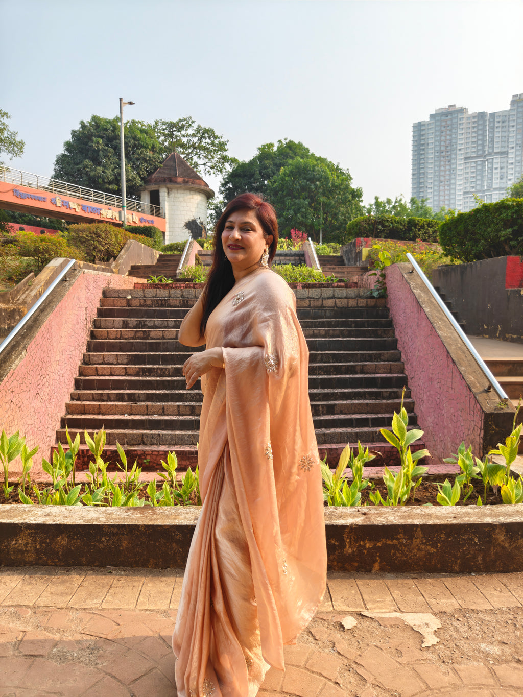 Elevate your festive & party look with this Champagne Gold Ready to Wear Saree from Aura Drapes by Unbox Colours. Designed for effortless draping, this pre-stitched saree combines timeless grace with modern comfort. Crafted in lightweight flowy fabric with delicate embellishments, it's perfect for festivals, weddings, parties & special occasions. Style, comfort & sophistication - ready in minutes.

It's peachy tone, combined with a modern, functional design, make it the perfect choice for every occasion.