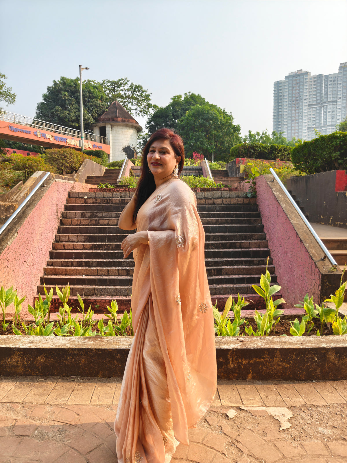 Elevate your festive & party look with this Champagne Gold Ready to Wear Saree from Aura Drapes by Unbox Colours. Designed for effortless draping, this pre-stitched saree combines timeless grace with modern comfort. Crafted in lightweight flowy fabric with delicate embellishments, it's perfect for festivals, weddings, parties & special occasions. Style, comfort & sophistication - ready in minutes.

It's peachy tone, combined with a modern, functional design, make it the perfect choice for every occasion.