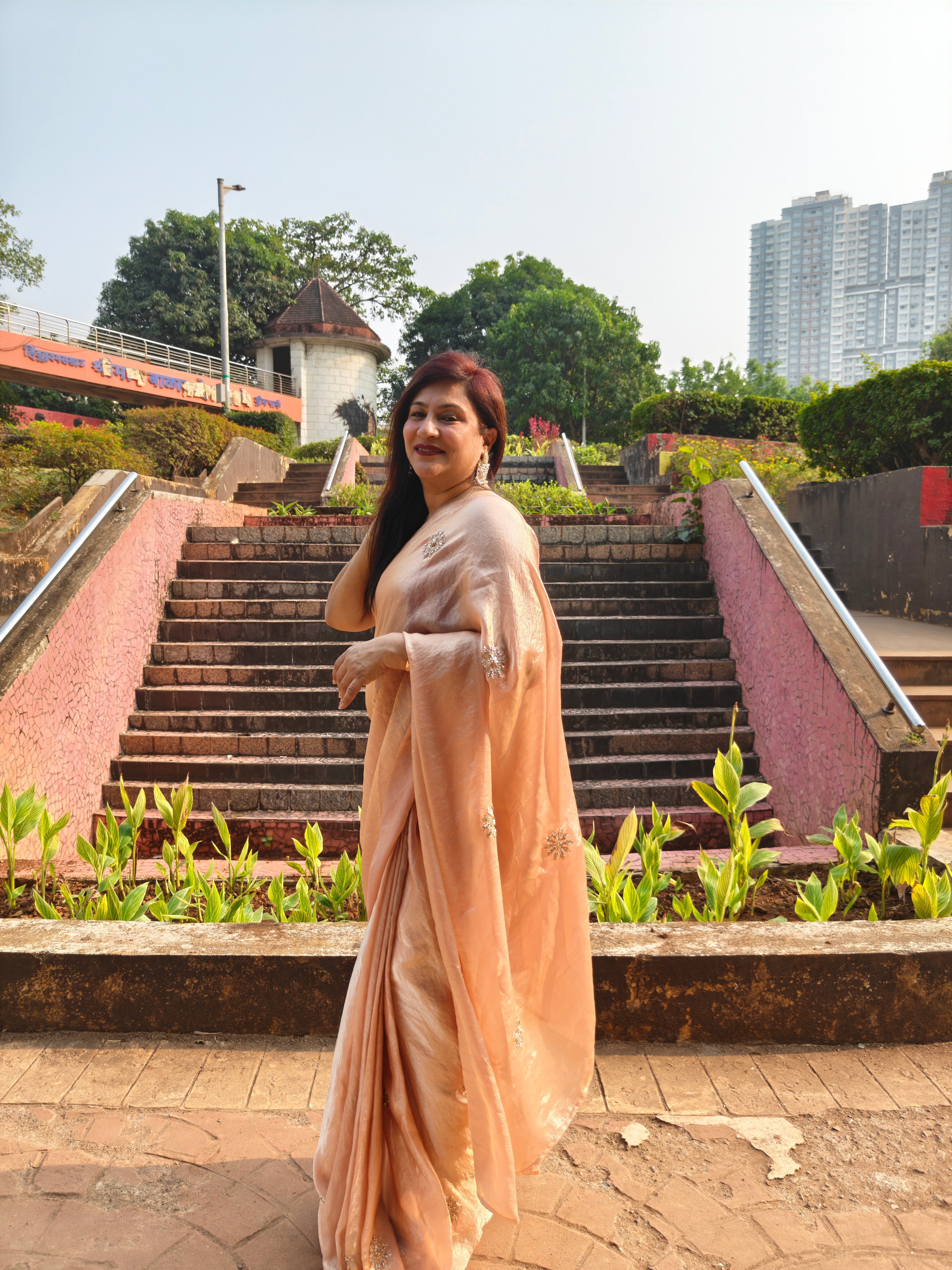 Elevate your festive & party look with this Champagne Gold Ready to Wear Saree from Aura Drapes by Unbox Colours. Designed for effortless draping, this pre-stitched saree combines timeless grace with modern comfort. Crafted in lightweight flowy fabric with delicate embellishments, it's perfect for festivals, weddings, parties & special occasions. Style, comfort & sophistication - ready in minutes.

It's peachy tone, combined with a modern, functional design, make it the perfect choice for every occasion.