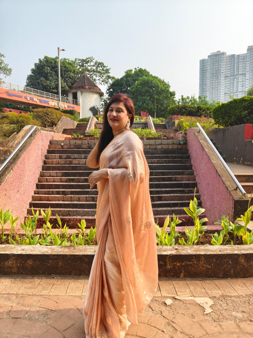 Elevate your festive & party look with this Champagne Gold Ready to Wear Saree from Aura Drapes by Unbox Colours. Designed for effortless draping, this pre-stitched saree combines timeless grace with modern comfort. Crafted in lightweight flowy fabric with delicate embellishments, it's perfect for festivals, weddings, parties & special occasions. Style, comfort & sophistication - ready in minutes.

It's peachy tone, combined with a modern, functional design, make it the perfect choice for every occasion.