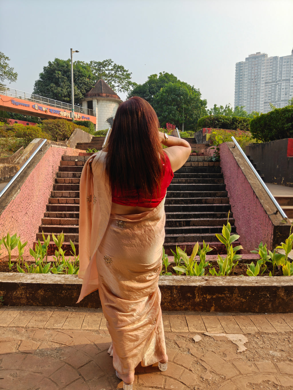 Elevate your festive & party look with this Champagne Gold Ready to Wear Saree from Aura Drapes by Unbox Colours. Designed for effortless draping, this pre-stitched saree combines timeless grace with modern comfort. Crafted in lightweight flowy fabric with delicate embellishments, it's perfect for festivals, weddings, parties & special occasions. Style, comfort & sophistication - ready in minutes.

It's peachy tone, combined with a modern, functional design, make it the perfect choice for every occasion.