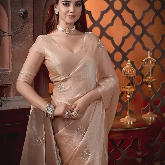 Elevate your festive & party look with this Champagne Gold Ready to Wear Saree from Aura Drapes by Unbox Colours. Designed for effortless draping, this pre-stitched saree combines timeless grace with modern comfort. Crafted in lightweight flowy fabric with delicate embellishments, it's perfect for festivals, weddings, parties & special occasions. Style, comfort & sophistication - ready in minutes.

It's peachy tone, combined with a modern, functional design, make it the perfect choice for every occasion.
