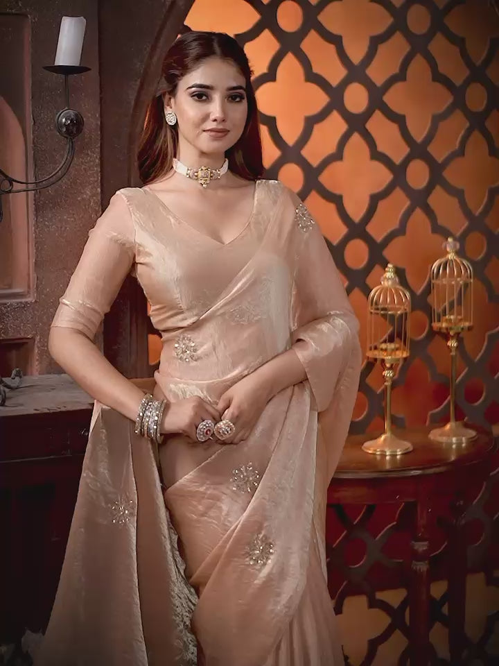 Elevate your festive & party look with this Champagne Gold Ready to Wear Saree from Aura Drapes by Unbox Colours. Designed for effortless draping, this pre-stitched saree combines timeless grace with modern comfort. Crafted in lightweight flowy fabric with delicate embellishments, it's perfect for festivals, weddings, parties & special occasions. Style, comfort & sophistication - ready in minutes.

It's peachy tone, combined with a modern, functional design, make it the perfect choice for every occasion.